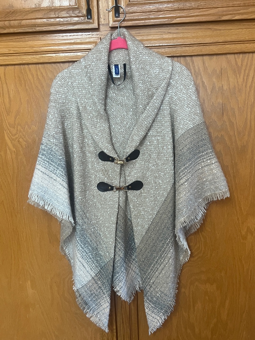Poncho style sweater with front clips